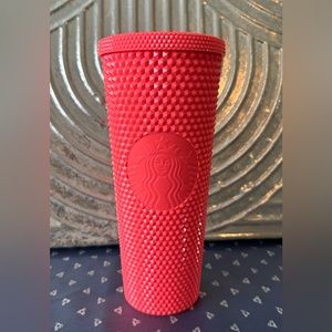 Starbucks pink studded tumbler.